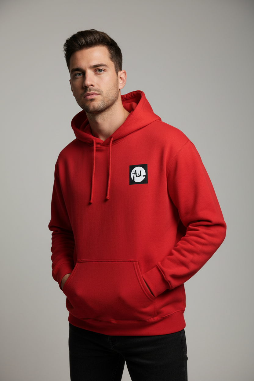 A white hooded sweatshirt with a kangaroo pocket and drawstring hood, featuring a small square black and white logo on the upper left front side.